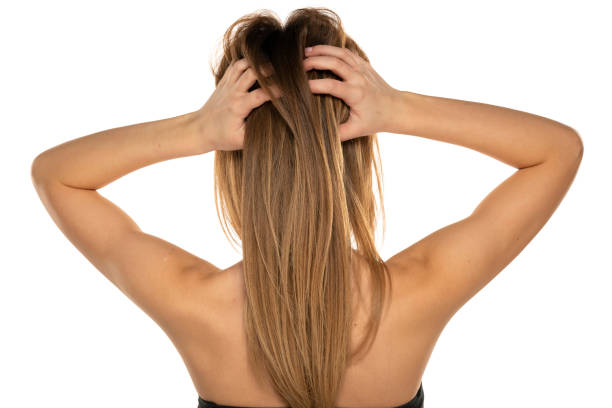istock Rear view of a young woman scratching her head 1418224724
