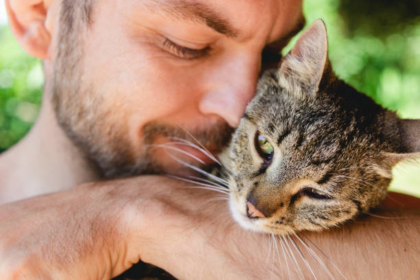istock Man hugging his cat, affection of owners to their pets. 1418224798