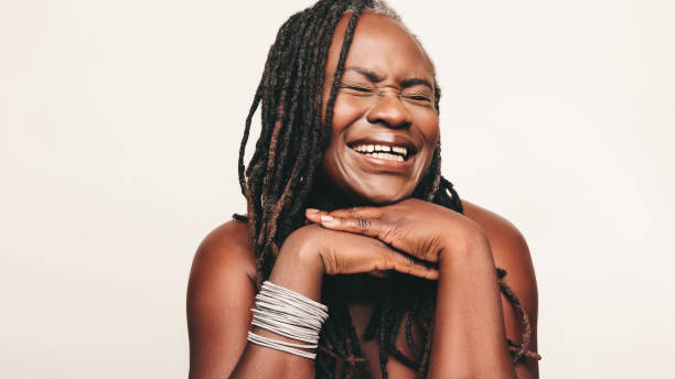 istock Joyful woman laughing happily against a studio background 1418226689