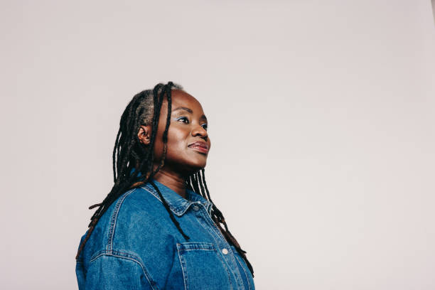 istock Woman with dreadlocks looking away thoughtfully in a studio 1418226723