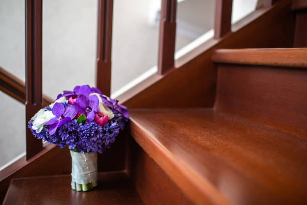 A row of Bridesmaids at a wedding wearing purple and carrying bouquets.