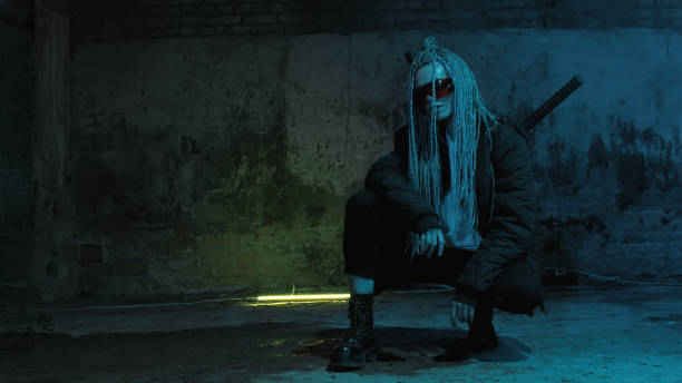 istock girl with dreadlocks and katanas in red glasses posing against a neon brick wall 1418228191