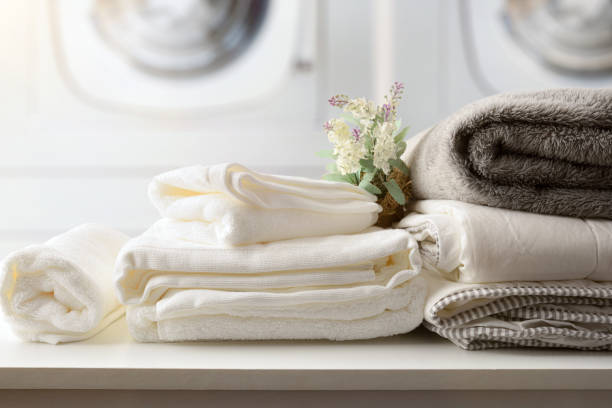 istock Self-service laundry with textiles on bench and washing machines detail 1418228369