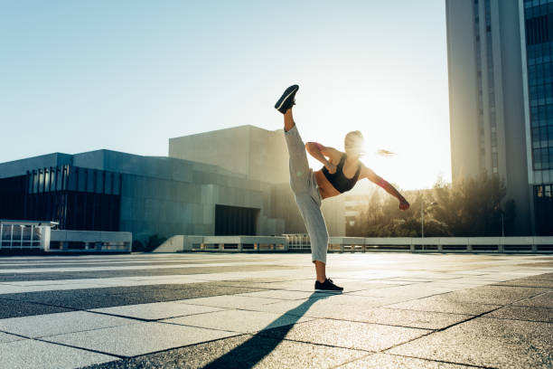 istock Woman practicing martial arts outdoors 1418228436