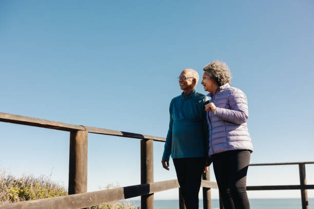 istock Happy senior couple looking at a refreshing view at the beach 1418229069