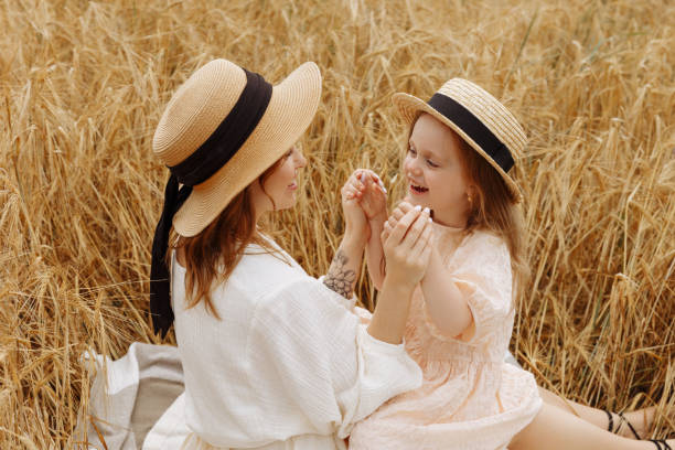 istock Mom and daughter in a wheat field 1418232245