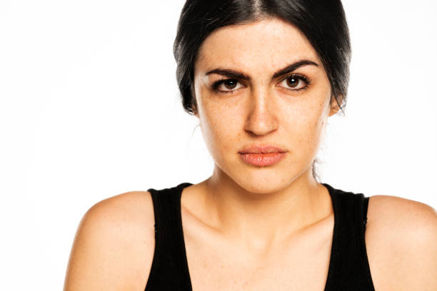 istock a young suspicious woman without makeup 1418232514
