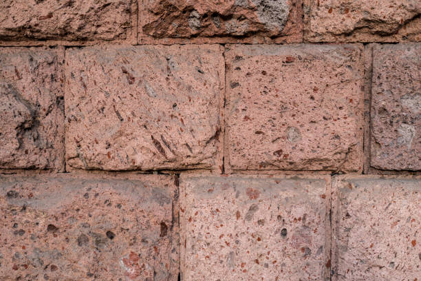 Wall texture with rough cut Quarry-faced masonry ashlar in red and brown