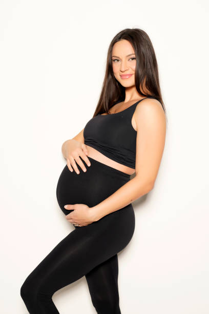 https://media.istockphoto.com/id/1418233252/photo/a-pregnant-young-woman-posing-in-black-leggings-and-a-shirt.jpg?s=612x612&w=0&k=20&c=SHkJvOw1EKcu3F3LC9sKLItqP-EipIVCb01tE_oTy8M=