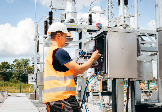istock Adult electrical engineer mount the electrical systems at the equipment control cabinet. Installation of modern electrical station 1418233752