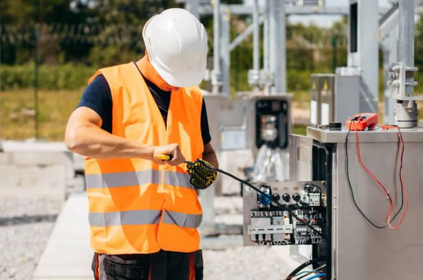 istock Adult electrical engineer mount the electrical systems at the equipment control cabinet. Installation of modern electrical station 1418233762
