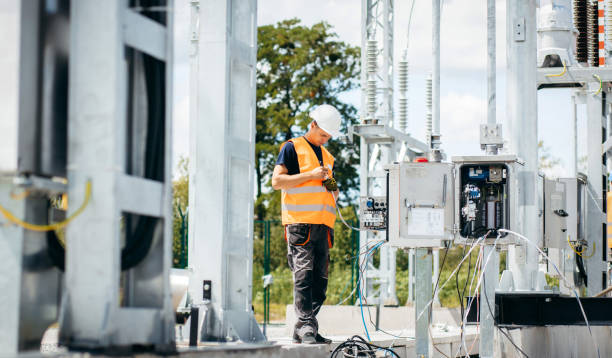 istock Adult electrical engineer mount the electrical systems at the equipment control cabinet. Installation of modern electrical station 1418233765