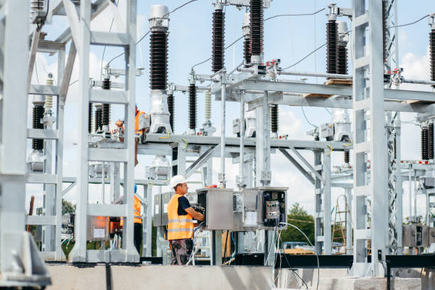 istock Adult electrical engineer mount the electrical systems at the equipment control cabinet. Installation of modern electrical station 1418233824