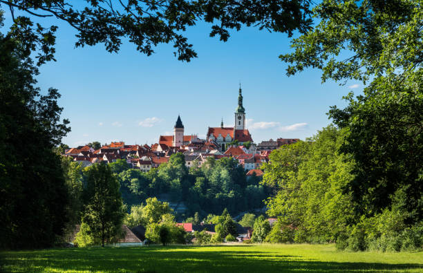 istock Beautiful look to scenic Tabor old town framed by green tree branches on a blue sky 1418234009