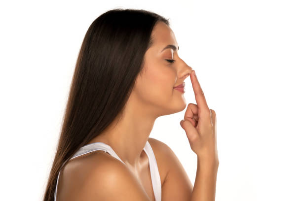 istock smiling woman touching her nose 1418234074
