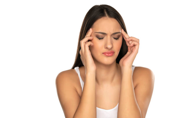 istock a young woman with strong headache 1418234236
