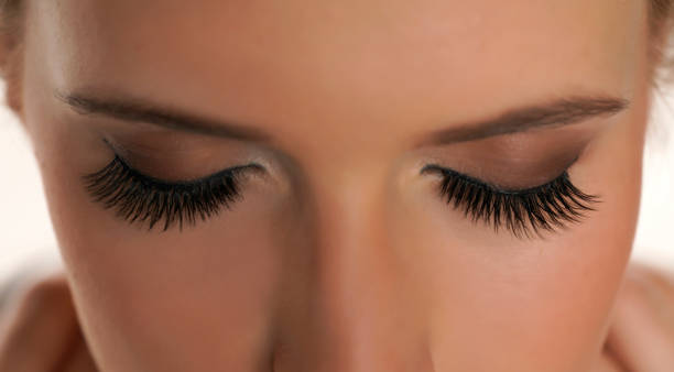 istock Woman with beautiful eyelashes after extension procedure 1418235621