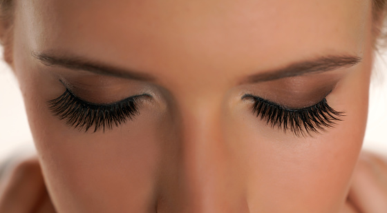 Woman with beautiful eyelashes after extension procedure, closeup
