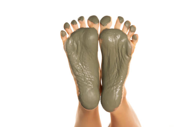 istock female feet with green mud mask on a white background 1418238107