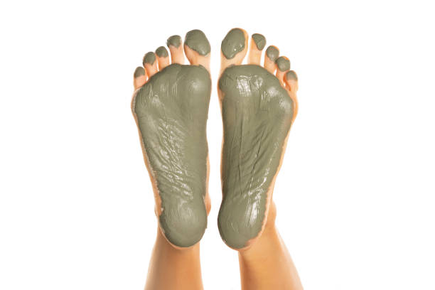 istock female feet with green mud mask on a white 1418238114