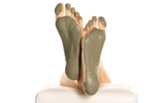 istock female feet with green mud mask on a white 1418238115