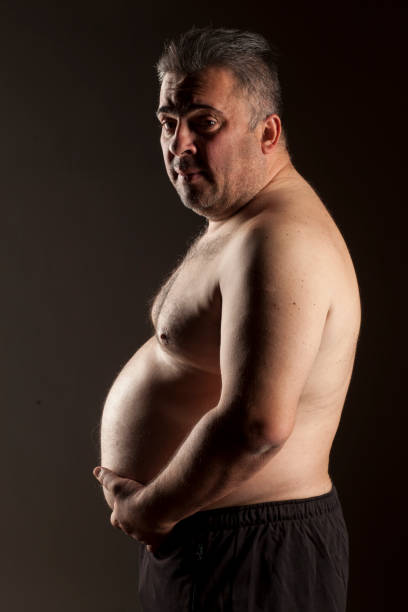 istock fat shirtless man posing in the studio 1418239737