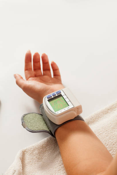 istock a blood pressure measuring device on a woman's hand 1418240382