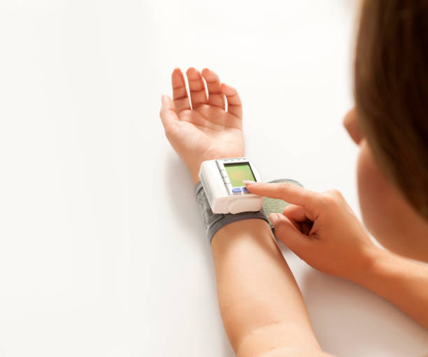 istock a blood pressure measuring device on a woman's hand 1418240396