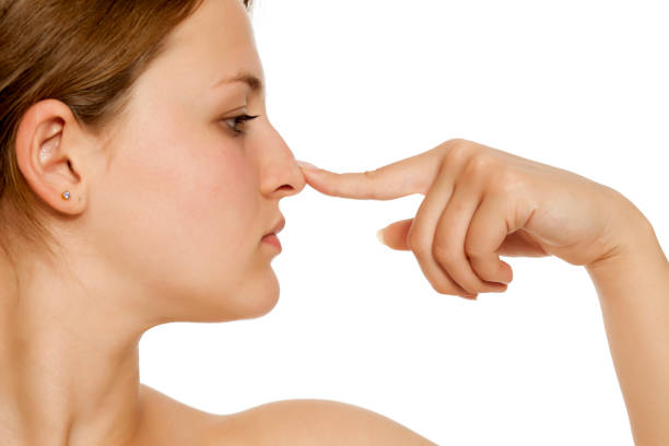 istock A young woman touching her nose with her finger 1418240414