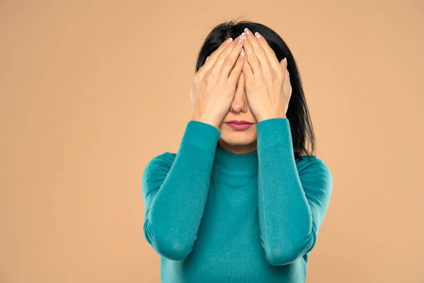istock Middle aged woman covering her eyes 1418240574