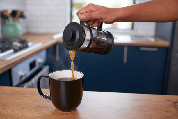 istock A close up of hand pouring fresh filter coffee into a mug in a clean kitchen 1418240856
