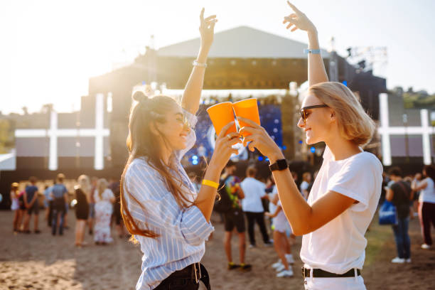 Two young woman  having a great time at a music festival. stock photo