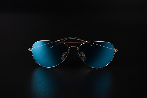 Closeup of generic, mass produced sunglasses on a white background.