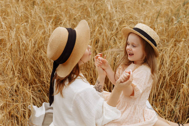 istock Mom and daughter in a wheat field 1418251765