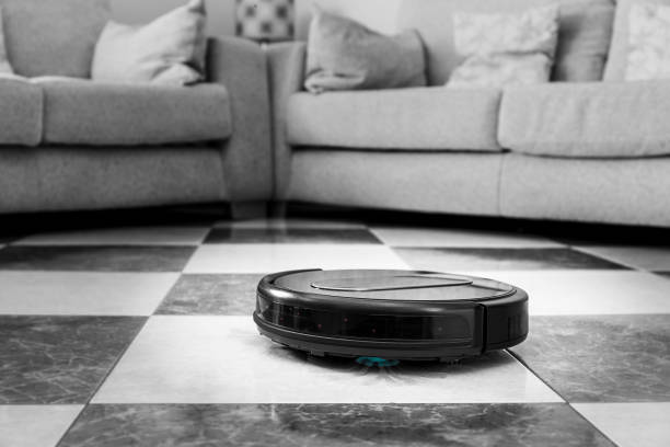 istock Robot vacuum cleaner cleaning living room floor 1418258065