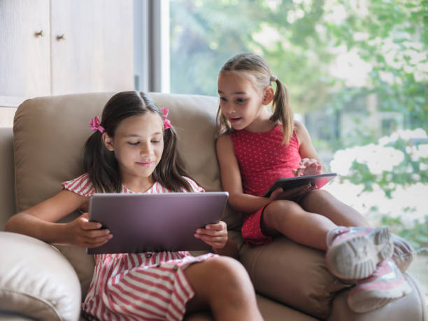 istock Children Using Laptop Compute And Digital Tablet At home, Cross Device Group Concept 1418259280