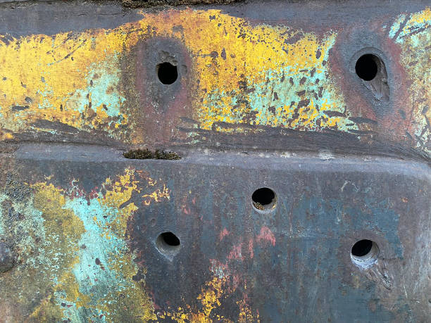 istock Close-up rusty metal with holes orange blue 1418260508