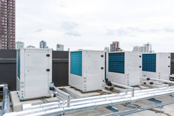 istock Air conditioner compressor installed on roof building.  Industrial air conditioning units. Industrial air conditioning and ventilation systems on roof. Cooling towers in data center building. 1418260970