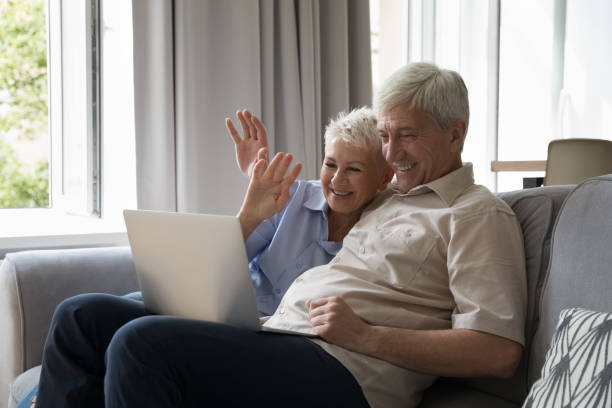 istock Mature couple talking to grownup children use videoconference on laptop 1418261637
