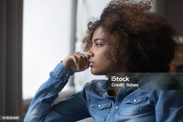 Closeup Face African Sad Thoughtful Teenager Girl Looking Into Distance Stock Photo - Download Image Now