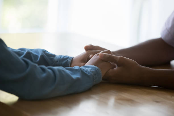 istock Closeup African couple holding hands express support and trust 1418261687