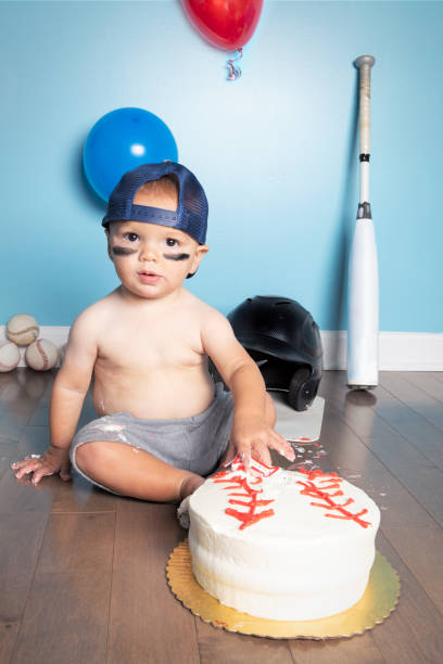 istock Birthday Boy Putting Hands in Baseball Cake 1418262891