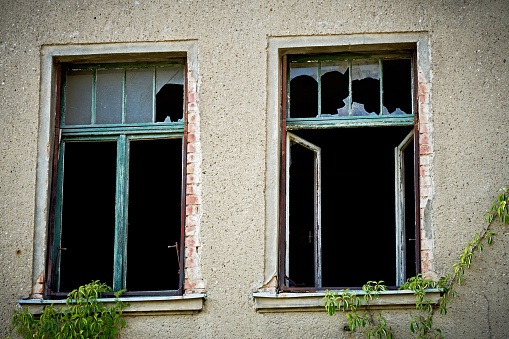 Broken windows in an old storage building