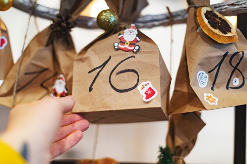 Original Christmas Advent Calendar made of paper bag and clip on wooden table