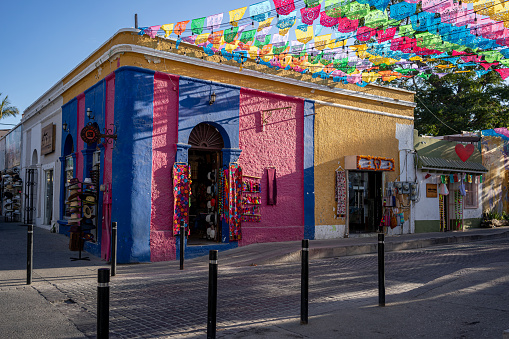 San Jose del Cabo, Baja Sur, Mexico - April 8th, 2022:A shop on the corner of Calle Alvaro Obregon and Miguel Hidalgo in San Jose del Cabo, Mexico Baja Sur in the arts district with colorful flags above the streets.