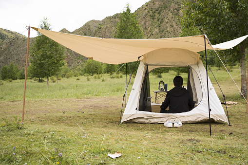 Leisure time for Asian men camping outdoors