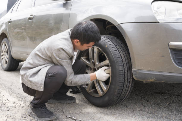 istock A man is changing a car tire 1418272365