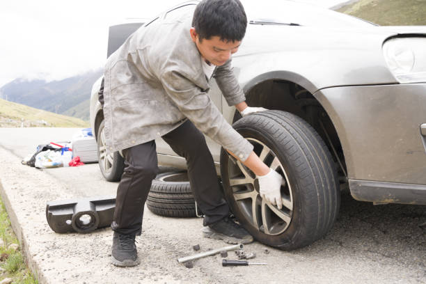 istock A man is changing a car tire 1418272370