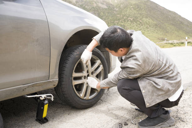 istock A man is changing a car tire 1418272384