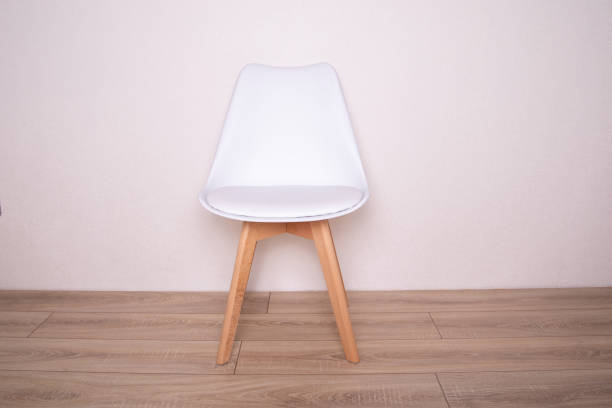 istock White chair on wooden background 1418273371